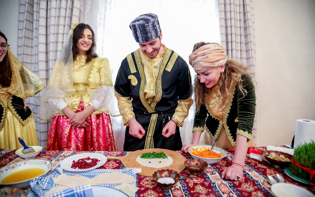 George-Deek-and-his-wife-Anna-to-his-right-learning-to-cook-Azerbaijani-traditional-food-during-major-holiday-of-Novruz-at-Baku-home-of-Fakhranda-Hasanzadeh-woman-leaning-March-20221-1024x640